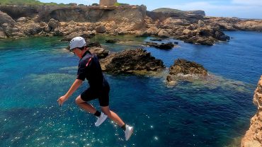 Family kid coasteering in Ibiza at Cala Comte with an optional guided sea jump