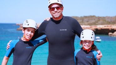 Family coasteering in Ibiza at Cala Comte with helmets and wetsuits
